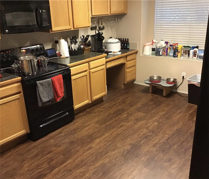 a kitchen with brown vinyl flooring