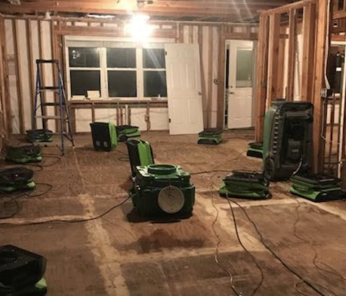 an empty room with green drying equipment
