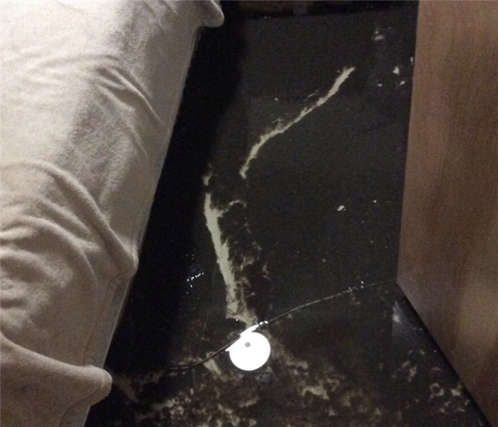 water on the floor of a bedroom