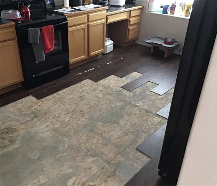 a kitchen with the flooring being removed