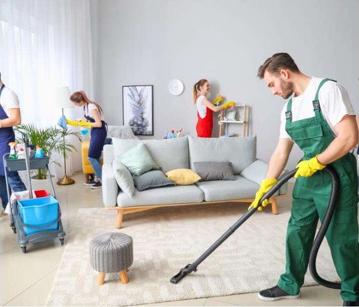 Professionals deep cleaning the living room